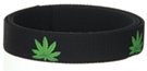 single green marijuana leaves on black webbing